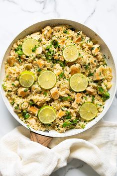 a white bowl filled with rice and limes