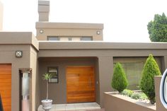 a modern house with wooden doors and windows