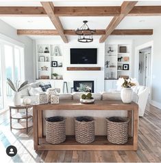 a living room filled with furniture and a fire place next to a tv mounted on a wall