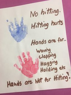 a handprinted sign that reads, no hitting hitting hurts hands are for wagging hugging holding at hands are not for hitting