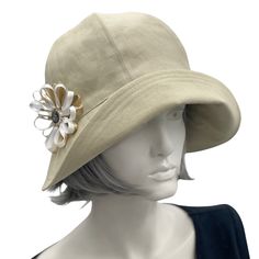 Polly wide front brim beige ,linen cloche hat with ribbon flower and button brooch Beige Cloche Bucket Hat For Summer, Elegant Bucket Hat For Spring, Elegant Spring Bucket Sun Hat, Elegant Spring Bucket Hat, Spring Cloche Hat With Curved Brim, Adjustable Cloche Bucket Hat For Spring, Classic Brimmed Bucket Hat For Spring, Gatsby Style Adjustable Cloche Hat With Curved Brim, Adjustable Gatsby Cloche Hat With Curved Brim