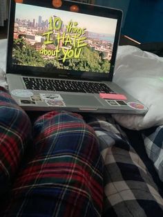 an open laptop computer sitting on top of a bed