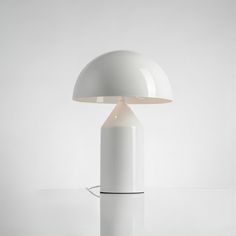 a white table lamp sitting on top of a counter