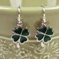 "Cute, simple and dainty green enamel shamrock charms dangle .5\" (1 cm) from sterling silver ear wires. ❖  enamel shamrock charms ❖  sterling silver ear wires ❖  rubber stoppers Earrings shown are on french hook ear wires. All earring types are sterling silver with the exception of clip-ons, which are silver plated. Hypoallergenic french hooks are stainless steel. ⊱✿ Matching necklace: https://kimsbling.etsy.com/listing/581261924/green-shamrock-and-swarovski-crystal?utm_source=Copy&utm_medium=ListingManager&utm_campaign=Share&utm_term=so.lmsm&share_time=1694811927737" Green Enamel Charm Jewelry, Green Charms Jewelry For Good Luck, Green Enamel Jewelry With Charms, Nickel-free Enamel Drop Earrings, Adjustable Green Enamel Jewelry, Green Charms Jewelry Perfect For Gifts, Green Teardrop Enamel Jewelry, Sterling Silver Dangle Earrings With Charms, Sterling Silver Drop Earrings With Charms