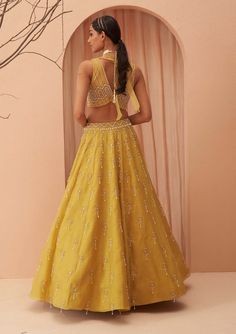 Editors Note Elevate your elegance with this stunning yellow lehenga set adorned with cascading pearls and glistening glass beads. The intricate detailing and exquisite craftsmanship make it a perfect choice for weddings and grand celebrations, ensuring you shine with timeless beauty and grace. Elegant Yellow Floor-length Palazzo Set, Yellow Palazzo Set With Zari Work For Reception, Elegant Yellow Anarkali Set For Navratri, Elegant Yellow Choli With Traditional Drape, Elegant Yellow Anarkali Set For Festive Occasions, Elegant Yellow Sets For Navratri, Elegant Yellow Festive Palazzo Set, Elegant Festive Yellow Palazzo Set, Elegant Yellow Anarkali Set With Pallu