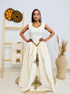 This modern Habesha dress combines sleek lines with a shape-enhancing design, offering a stylish and contemporary look for women. Perfect for any occasion, it blends traditional elegance with modern flair, making it a standout choice for everyday sophistication. Key Features: Cultural Heritage: Adorned with exquisite handwoven details that honor Ethiopia's rich traditions. Flattering Design: The flowing silhouette ensures you look stunning at weddings, festivals, or any event where you want to shine. Ethical Craftsmanship: Handmade by skilled Ethiopian artisans, embracing tradition while making a bold fashion statement. Care Instructions: For best results, we recommend gentle hand washing. Shipping Information: Processing Time: 10 days Delivery: Shipping usually takes 3 to 5 days if you ar Modern Habesha Dress, Ethiopian Dresses, Habesha Dress, Ethiopian Dress, Habesha Kemis, Modern Dress, Cultural Heritage, Ethiopia, Dress Clothes For Women