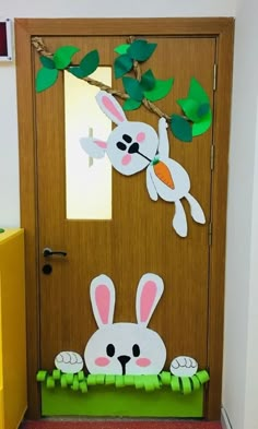 a door decorated with paper cut outs and bunny ears