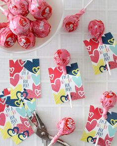 valentine's day lollipops on a table with scissors and napkins