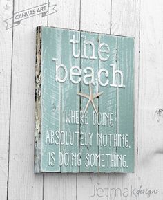 a wooden sign that says the beach where doing absolutely nothing is doing some thing on it