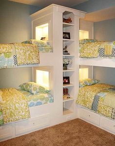 a room with three bunk beds in it and carpeted flooring on the ground