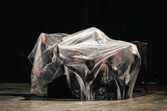 two chairs covered in plastic sitting on top of a stage