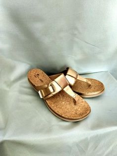 Flat flip-flop sandals with hook and adjustable loop closure. Brand: CLARK - Cloudsteppers Super soft cushion. Best quality faux leather. Color: Gold Size: US 9.1/2 Excellent condition. Slightly used. Thank you for visiting my store. You can also visit my MargaretJewelryShop or http://jewelryandclothing.net/ Adjustable T-strap Sandals With Ortholite Insole, Gold Open Toe Sandals With Leather Footbed, Gold Open Toe Footbed Sandals With Cushioned Sole, Gold Open Toe Footbed Sandals With Cushioned Footbed, Adjustable Round Toe Wedge Sandals With Cork-bed Midsoles, Gold Buckle Closure Slip-on Sandals, Gold Slip-on Sandals With Buckle Closure, Adjustable Gold Sandals With Buckle Closure, Adjustable Sandals With Textured Footbed And Round Toe