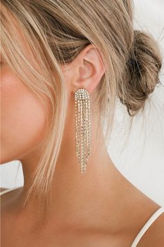 The Petit Moments Glitz Gold Rhinestone Tassel Earrings are just the kind of look that we wanna wear out (and get noticed in)! Elegant strands of shiny gold snake chain and clear rhinestone chains cascade from post backs. Pair with your favorite LBD and you'll easily make it a night to remember! Post backs. 3. 25" Long. 40% Zinc Alloy, 60% Glass. Imported. Lulus | Glitz Gold Rhinestone Tassel Earrings. Gold Hoco Jewelry, Prom Earrings Gold, Prom Dresses Accessories, Hoco Jewelry, Homecoming Jewelry, Rhinestone Tassel Earrings, Prom Gold, Fall Ball, Formal Earrings