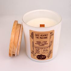 a white candle sitting next to a wooden lid