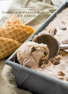 a scoop of ice cream sitting in a pan next to some waffles