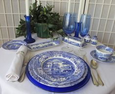 a blue and white table setting with place settings