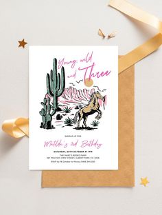 the desert wedding card features a horse, cactus and mountains with gold foil on it