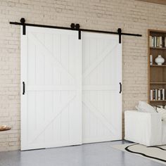 a living room with a white couch and two sliding doors that open up to the kitchen