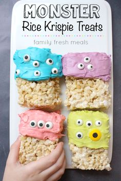 four rice krispy treats with eyes and mouths on them are being held by a person