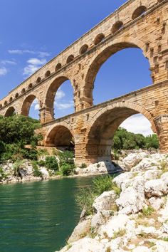 an old stone bridge spanning the width of a river