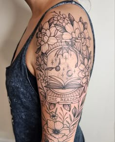 a woman's arm with a clock and flowers on it that says the reader