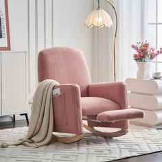 a pink chair and ottoman in a white room