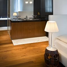 a living room and kitchen area with wood flooring