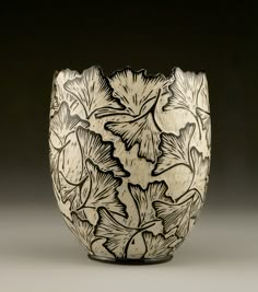 a black and white vase with flowers on it