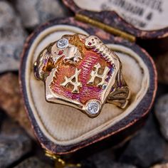 This antique JR Wood Creature Ring from the 1930s features great reddish purple to orange and blue patina with a wrap around creature that is accented with diamonds. The ring is crafted in 10k yellow gold and is currently a size 9.25. The ring has been sized before leaving the shank a bit rough, this will be fixed during the complimentary sizing or upon request. One of the diamonds is chipped. Heirloom Collectible 14k Stamped Ruby Ring, Vintage Diamond Ruby Ring For Collectors, Vintage Ruby Ring With Diamond For Collectors, Vintage Engraved Ruby Ring, Reddish Purple, Brand Presentation, Mens Rings Fashion, December Birthstone, Men's Rings