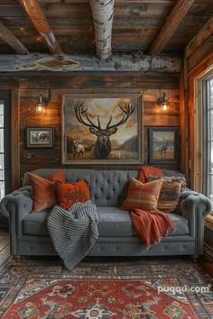 a living room filled with furniture and paintings on the wall next to a fire place