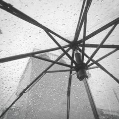 an open umbrella with rain drops on it