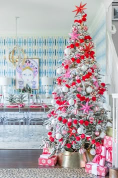 a christmas tree decorated with red, white and pink ornaments