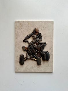 a sculpture made out of rocks with a woman riding a motorcycle on it's back