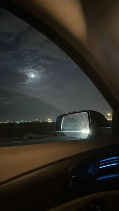 the rear view mirror of a car at night