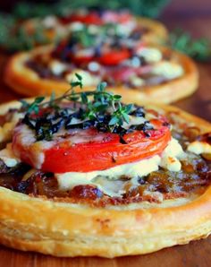 small pizzas with tomatoes, cheese and herbs