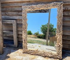 a mirror sitting on the side of a wooden building