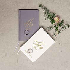 a ring sits on top of a book next to a flower