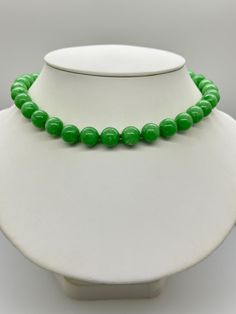 Green Jade Jadeite Bead Necklace.  This hand knotted necklace features 32 Green Jade Jadeite Beads Round Polished Grade AAA 11.9 to 12.4mm.  I hand knotted these with green silk thread and finished them with a 925 Silver Fold Over Magnetic Clasp.  The necklace measures 18 inches in length.  Please keep in mind that large beads take up space on the neck and they will fit tighter than an 18 inch chain.  The Beads are Genuine and Natural in color, no treatments.  The necklace pictured is the one you will receive.   It will arrive in a nice presentation box with a Certificate of Authenticity.   Please visit our Shop for more Pearls and Gemstone Jewelry. Sculpted Nails, Hand Knotted Necklace, Knotted Necklace, Large Beads, Green Jade, Green Silk, Silk Thread, Magnetic Clasp, Jade Green