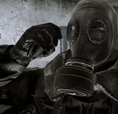 a man wearing a gas mask and gloves