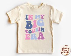 In my Big Cousin Era, Trendy Kid Shirt, ,Funny Toddler Shirt, Pregnancy Reveal T-Shirt, Siblings Shirt,  Cousin Natural Body, Cousin Sweater ✧ All of the t-shirts and bodysuits at our shop are made of 100% certified pure organic cotton. Elegant t-shirt with round neckline and short sleeves. The loose fit and softness of the cotton gives you freedom of movement. ✧Our sweatshirts are very soft, cute and lightweight, bound to keep you warm. Kid's unisex cotton blouse made of cotton with elastic at Playful Letter Print T-shirt For Gender Reveal, Fun Tops With Funny Print For Gender Reveal, Funny Letter Print T-shirt For Gender Reveal, Funny T-shirt For Gender Reveal With Letter Print, Gender Reveal Graphic Tee With Funny Text, Funny Toddler Shirt, Funny Toddler, Sibling Shirts, Toddler Humor