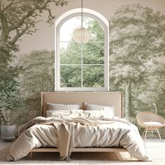 a large bed sitting under a window next to a forest wallpaper covered in trees