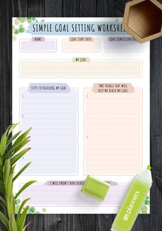 a simple goal setting worksheet on a wooden table next to a potted plant