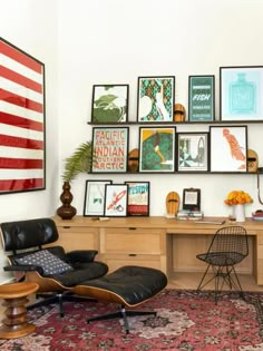 a living room with an american flag on the wall and many framed pictures above it