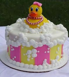 a decorated cake with a rubber duck in the tub