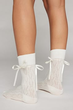 Oh-so-soft crew socks in a lightweight open knit. Tall crew sock style laced with a tonal satin ribbon tied with a bow for a sweet statement socks look. Features Ariana bow crew socks Seriously soft crew socks Tonal satin ribbon accent Bow detail Lightweight cotton blend Crew length Content + Care 80% Cotton, 15% polyester, 5% spandex Machine wash Imported Size Crew sock length Fits US women’s shoe size 6–10 | Ariana Bow Crew Sock in White, Women's at Urban Outfitters Cute Socks Aesthetic, Girly Socks, Sabrina Carpenter Concert, Cute Loungewear, Bow Socks, Statement Socks, Pretty Socks, Socks Aesthetic, Cute Lounge