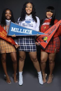 three young women holding signs and posing for a photo