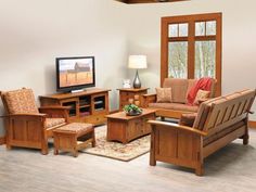 a living room filled with furniture and a flat screen tv on top of a wooden table