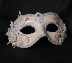 "This mask belongs to our collection of masks \"Into the White\", originally born for a special wedding and then further developed. This mask is a traditional and original papier-mache Venetian mask, handmade and decorated in our Atelier in Venice using acrylics colors, fabrics, Svarowski and the crequelè technique. It is perfect for any masquerade party, Halloween costume, pro or event in Venice or elsewhere during Carnival. This mask can be gently bent to form to your face and ties in the back White Formal Masquerade Mask For Carnival, White Venetian Masquerade Mask For Wedding, Venetian Masks And Prosthetics For Wedding And Mardi Gras, White Full Face Mask For Masquerade, Venetian Masquerade Mask For Wedding And Carnival, Elegant White Costume Mask, White Eye Mask For Wedding, Wedding And Mardi Gras Eye Mask, White Wedding Eye Mask