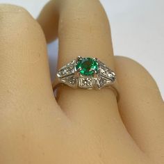 This is part of Chairish’s Fine Jewelry assortment.  Introducing the Emerald Diamond 0.90 Carat Platinum Filigree Milgrain Trim Engagement Ring, finger size 6.5 – a timeless symbol of your love and commitment. This exquisite piece combines classic elegance with intricate details, making it the perfect choice for your special moment. 1. Stunning Round Emerald, weighing 0.60 Carat and Diamonds weighing 0.30 Carat: At the heart of this engagement ring lies a breathtaking round emerald and diamonds. Classic Promise Ring With Birthstone Gemstone, Classic Gemstone Birthstone Ring For Promise, Classic Birthstone Ring For Promise, Classic Solitaire Emerald Promise Ring, Formal Solitaire Emerald Ring, Timeless Green Diamond Round Ring, Heirloom Style Diamond Emerald Promise Ring, Gia Certified Green Diamond Ring In Vintage Style, Timeless Brilliant Cut Emerald Anniversary Ring