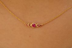 Add a touch of elegance with this stunning Natural Ruby Necklace, featuring a vibrant ruby set in a 14K solid gold bezel. A perfect gift for July birthdays or anyone who loves minimalist jewelry. The pendant captures the essence of timeless beauty, making it a versatile addition to any collection. Whether you're celebrating a special occasion or simply treating yourself, this necklace is an ideal choice. Take advantage of our exclusive Black Friday Sale and get this beautiful ruby pendant at an incredible price! Gold Ruby Necklace, Ruby Pendant Necklace, Pave Wedding Rings, Ruby Necklace Pendant, Necklace White Gold, Sapphire Wedding Band, Bezel Necklace